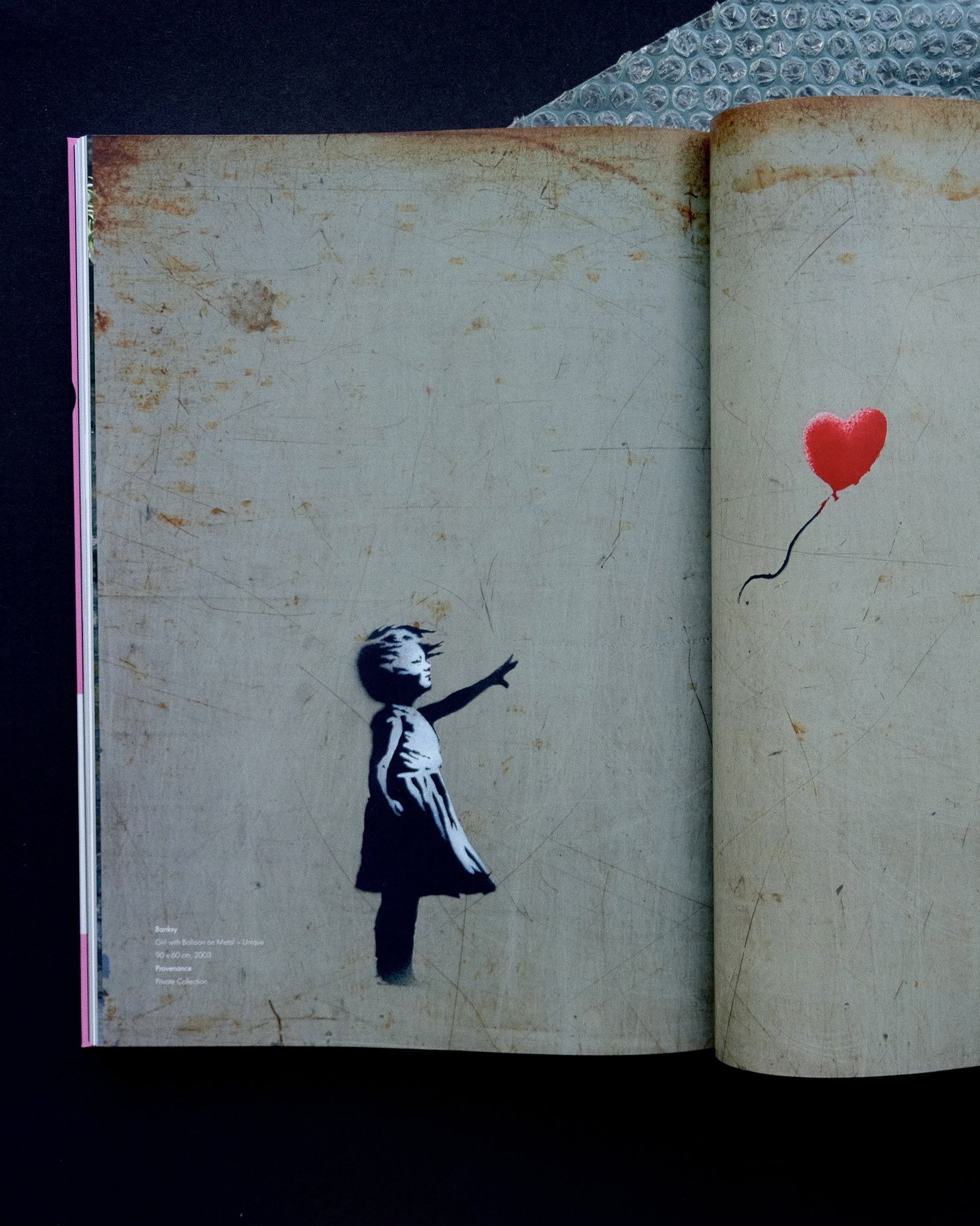 Interior page of the 'Laugh Now' catalogue, offering insights into Banksy's artistry and social commentary.