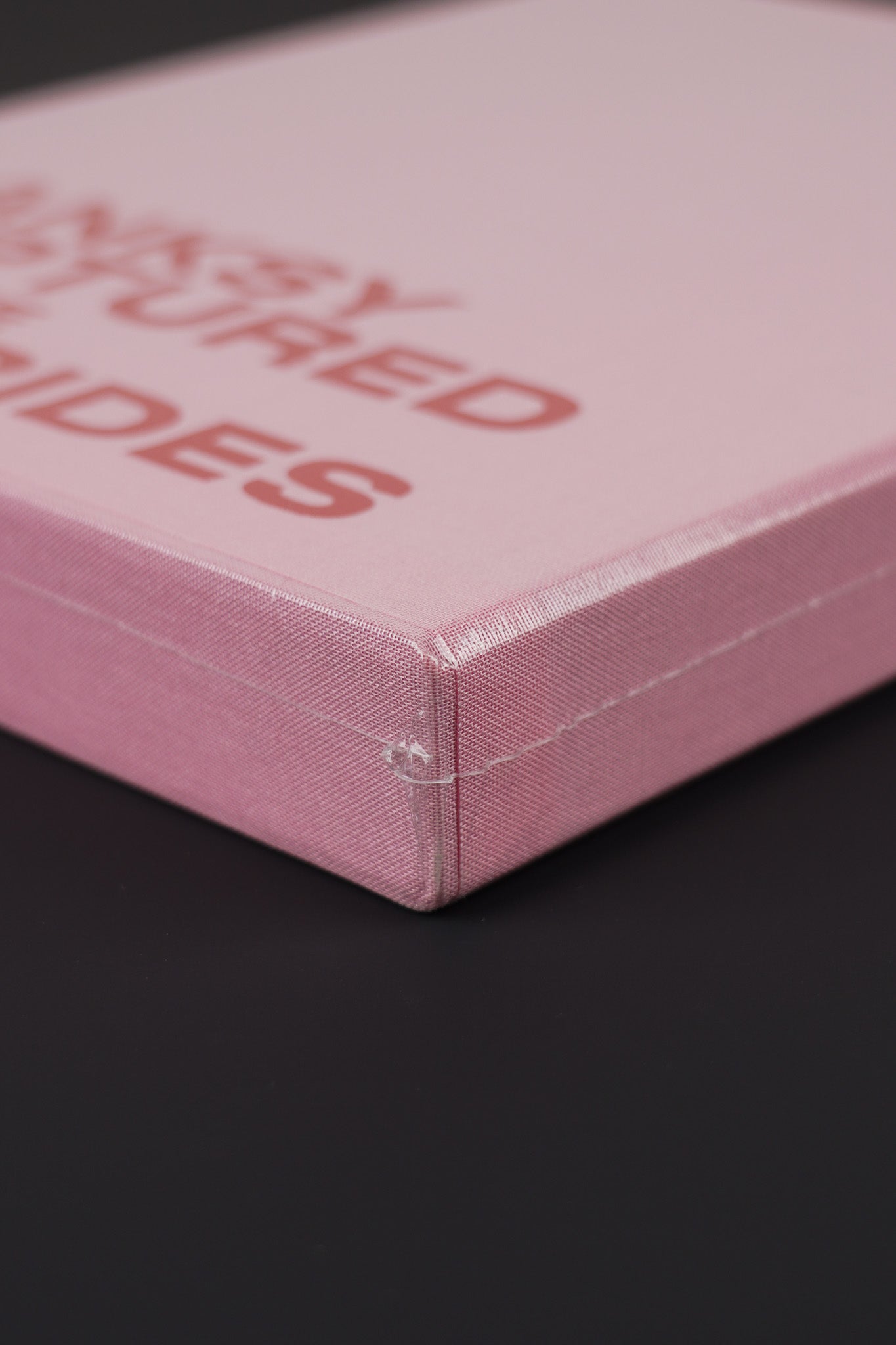 Close-up of the bottom corner of Banksy Captured Volume 2 slipcase, emphasizing its sturdy design and vibrant color.