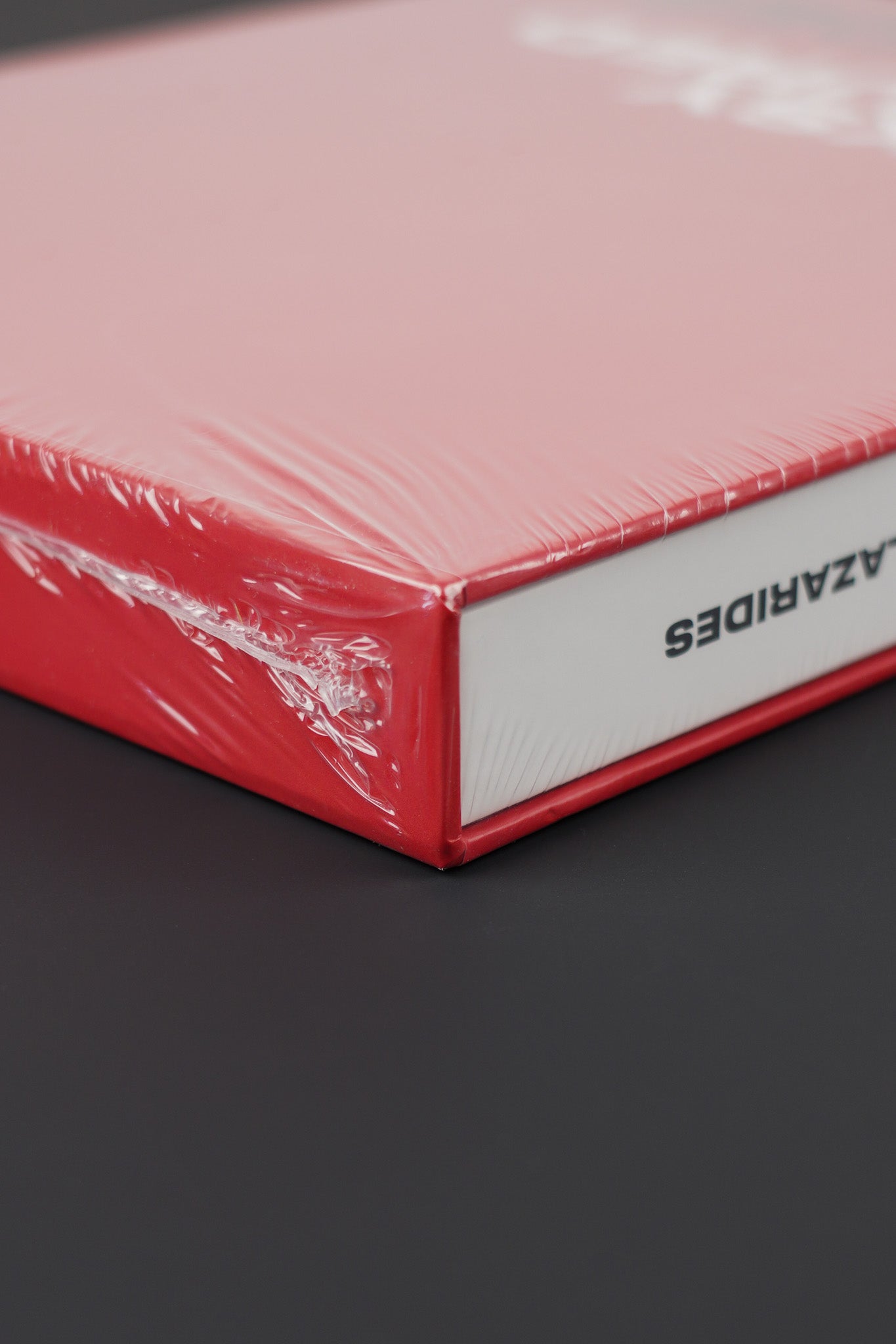 Detailed view of the upper corner of the sealed Banksy Captured red edition, showcasing slipcase texture.