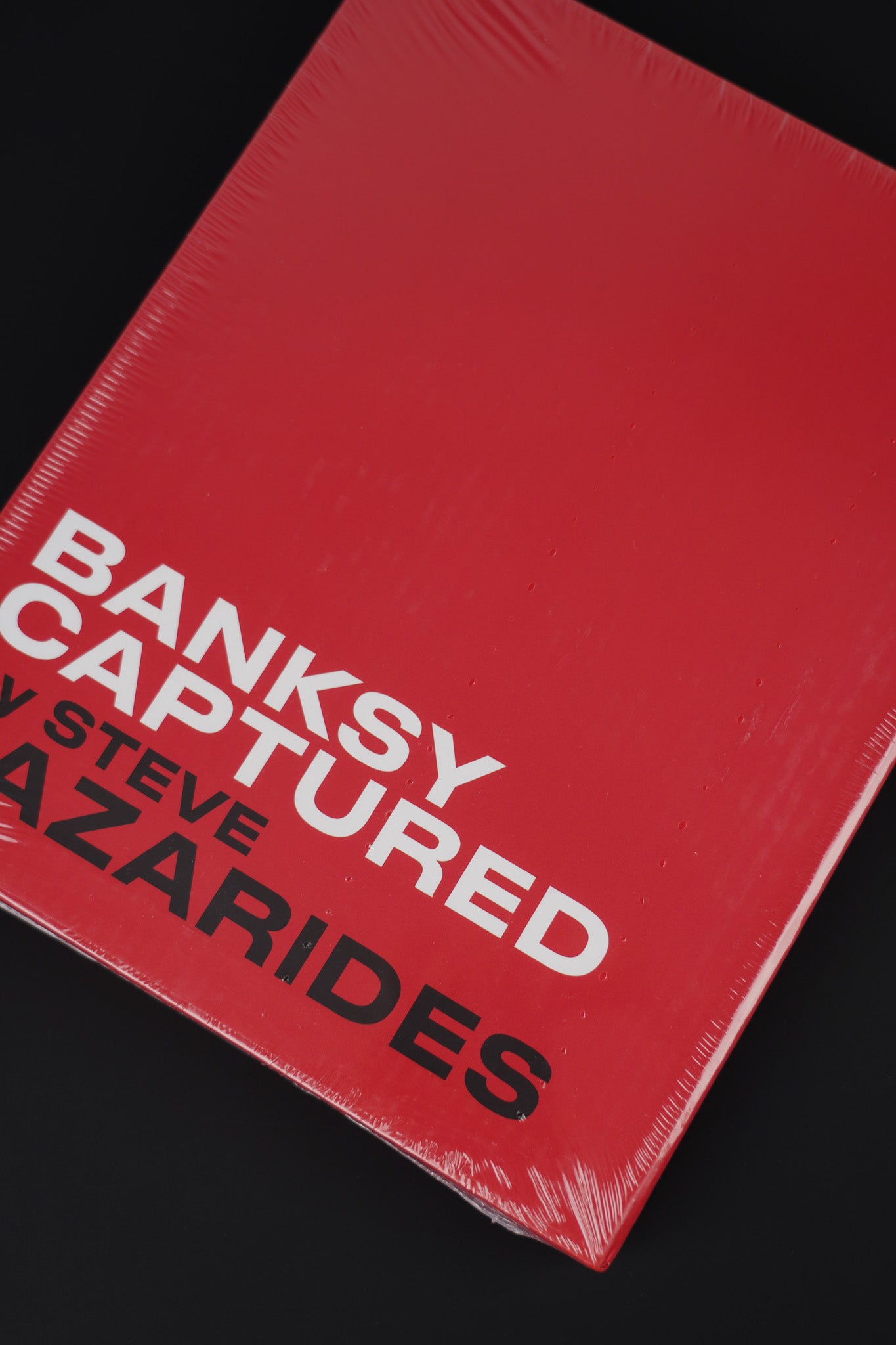 Sealed Banksy Captured hardcover in a red slipcase, combining premium design with exclusivity.