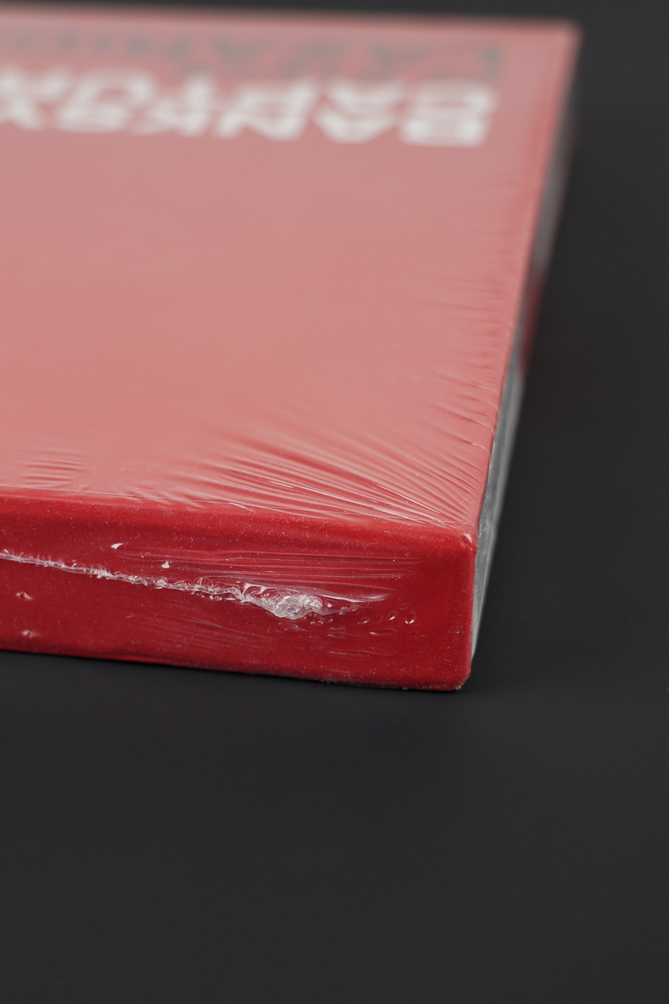 Side view of the Banksy Captured red slipcase, showcasing the intact seal.