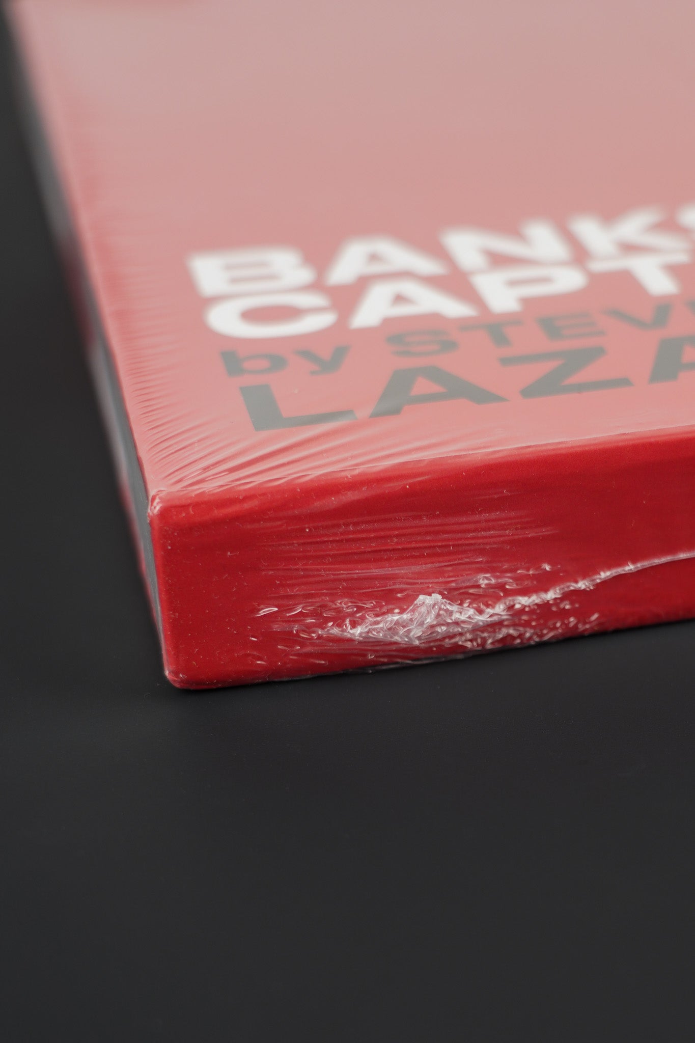 Side view of the Banksy Captured red slipcase, showcasing the intact seal.