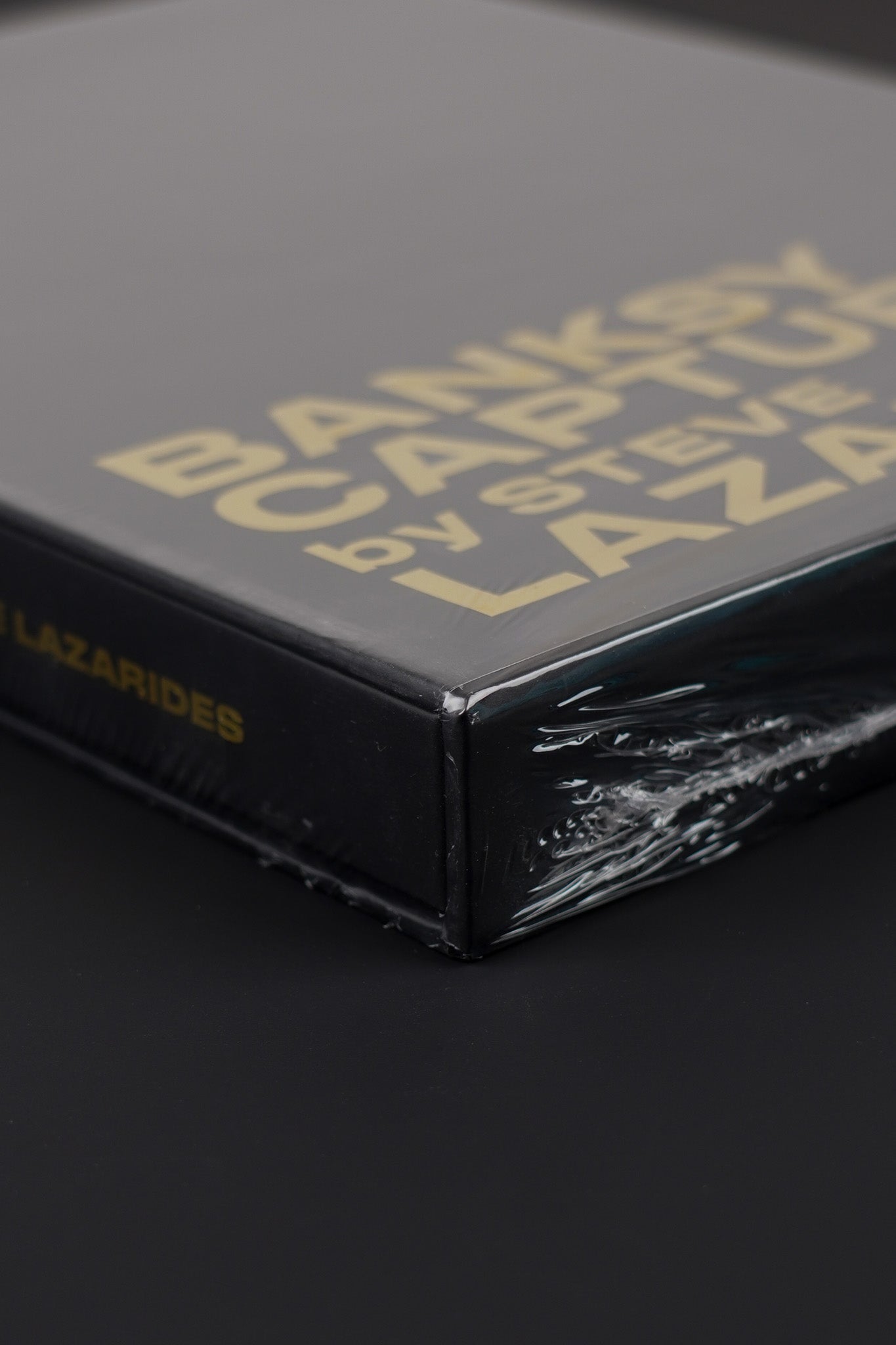 Close-up of the bottom corner of the Banksy Captured black slipcase, emphasizing its sharp edges and quality.