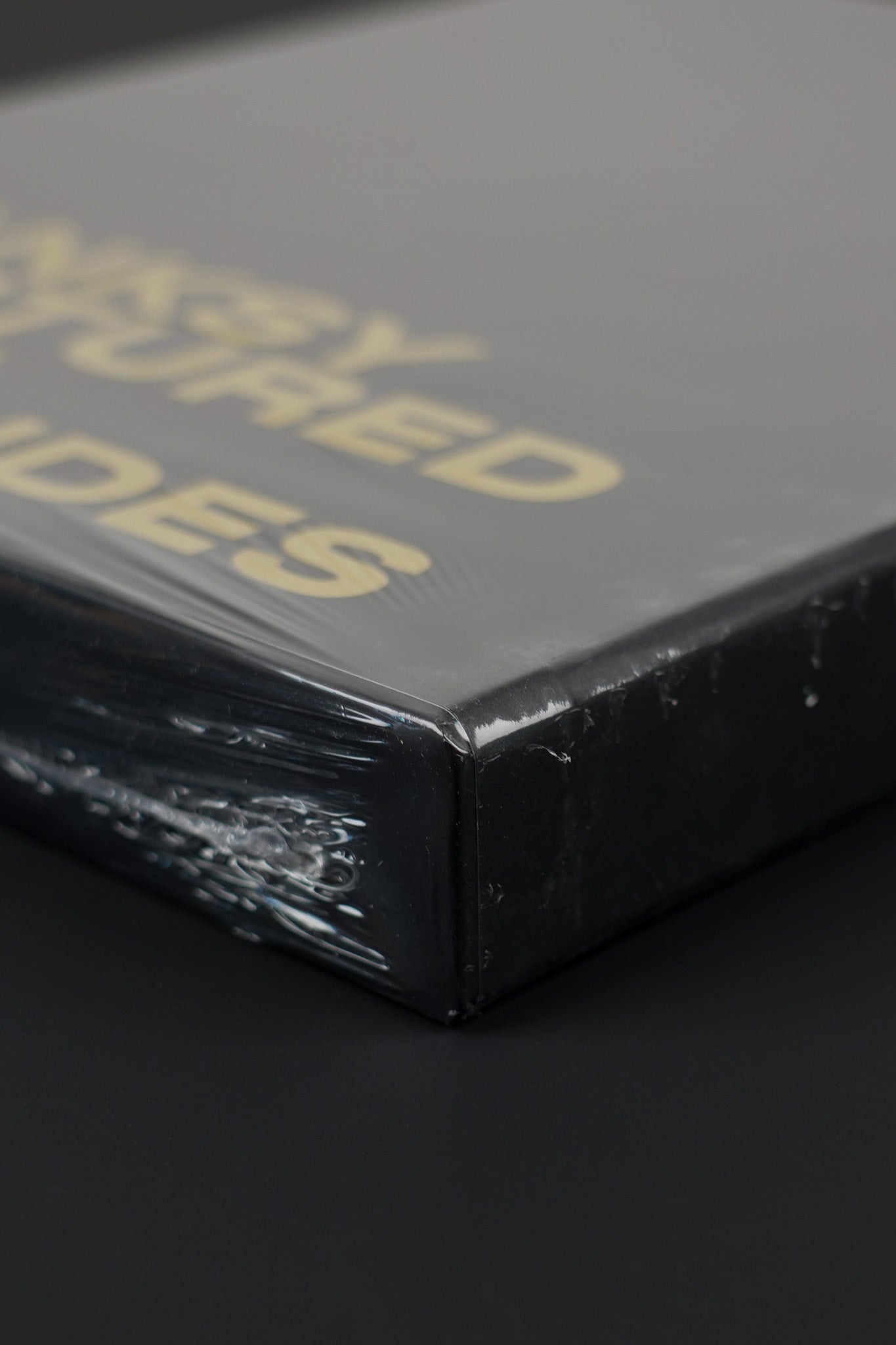 Close-up of the bottom corner of the Banksy Captured black slipcase, emphasizing its sharp edges and quality.