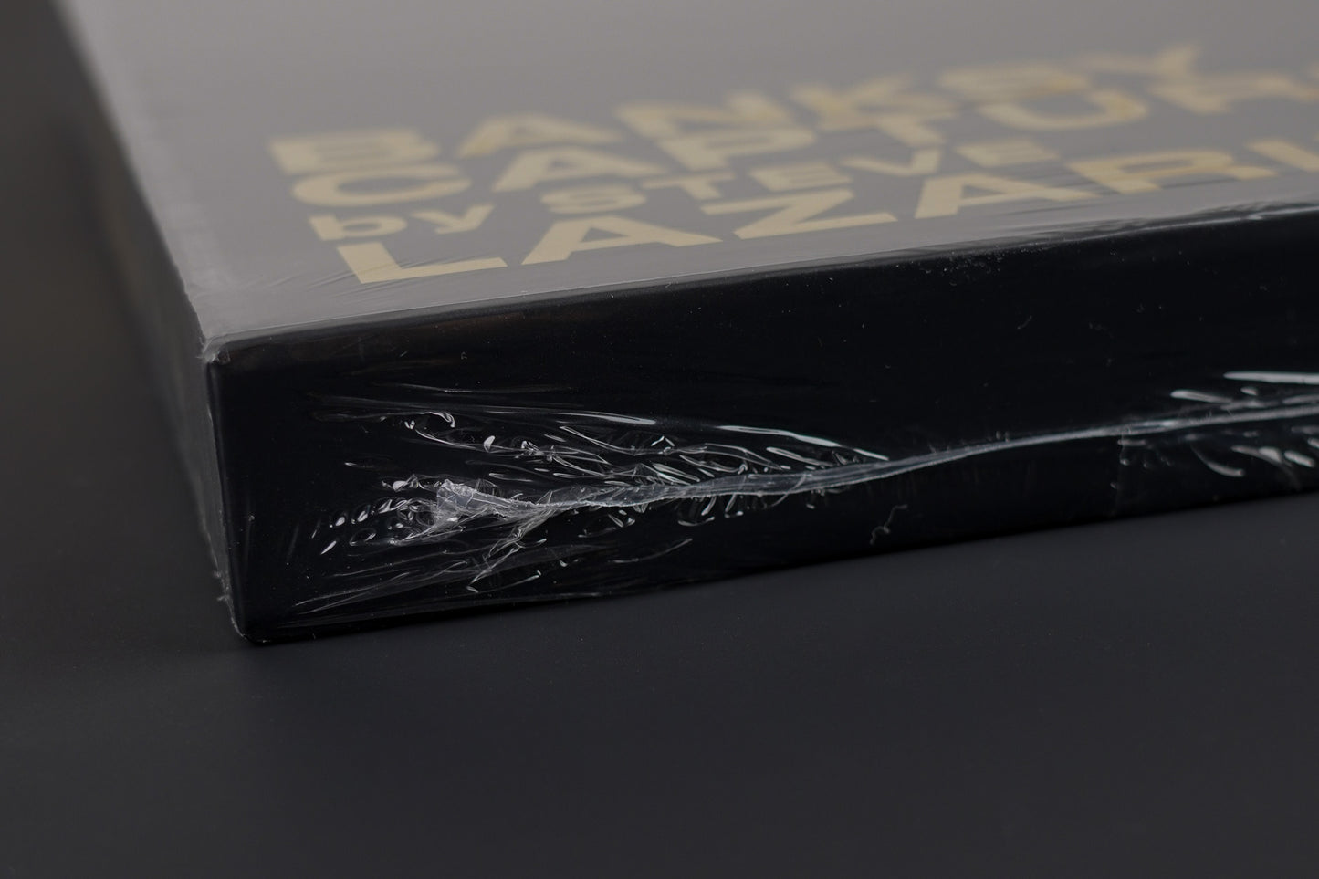 Close-up of the sealed side of the Banksy Captured black edition slipcase, emphasizing its untouched condition.