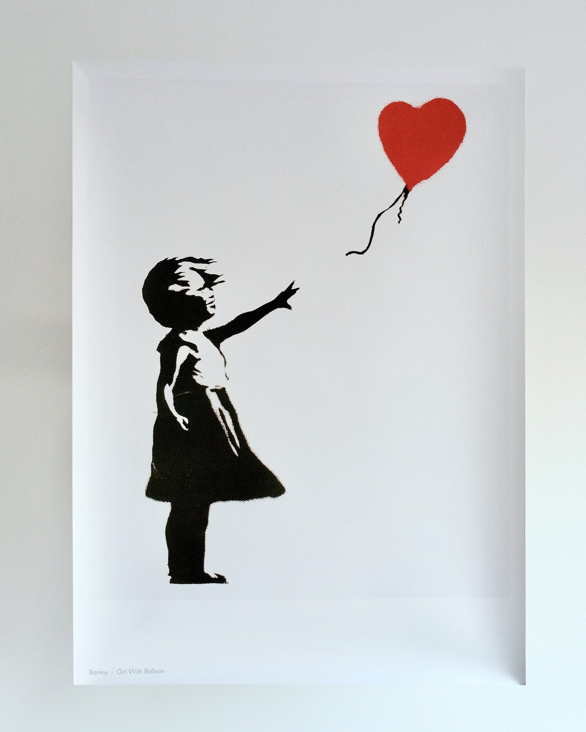 Detailed view of Banksy's 'Girl with Balloon' print, capturing the iconic and poignant street art piece.