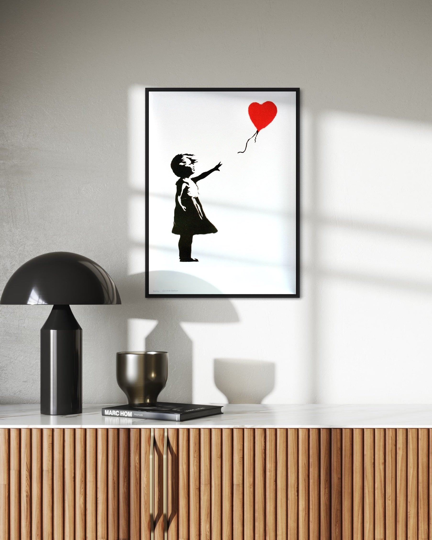 High-quality image of the framed 'Girl with Balloon' print by Banksy, showcasing the artwork's impact in a home setting.