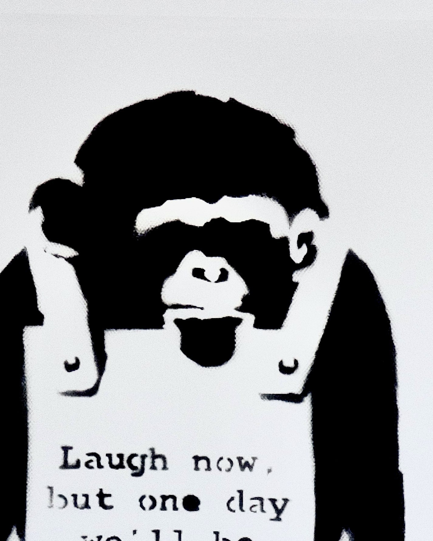 Close-up of the intersection between the monkey and the sign in Banksy's 'Laugh Now' print, highlighting the satirical imagery.