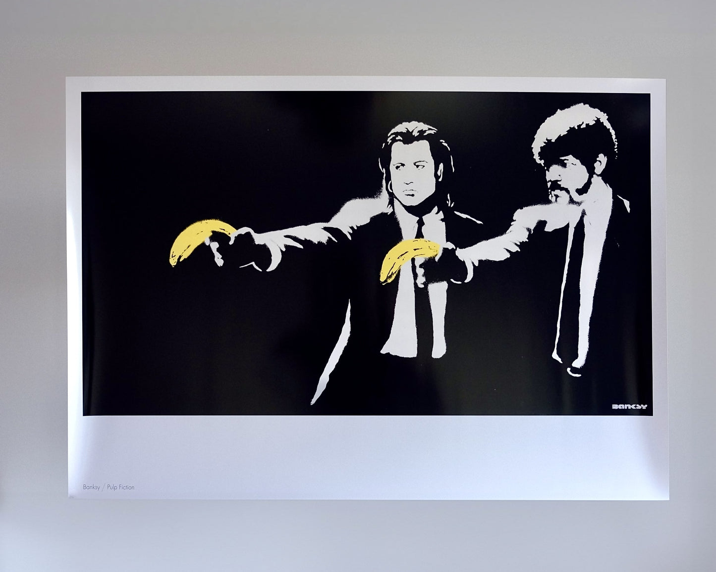 Detailed image of Banksy's 'Pulp Fiction' print, showing the characters with bananas in place of guns.