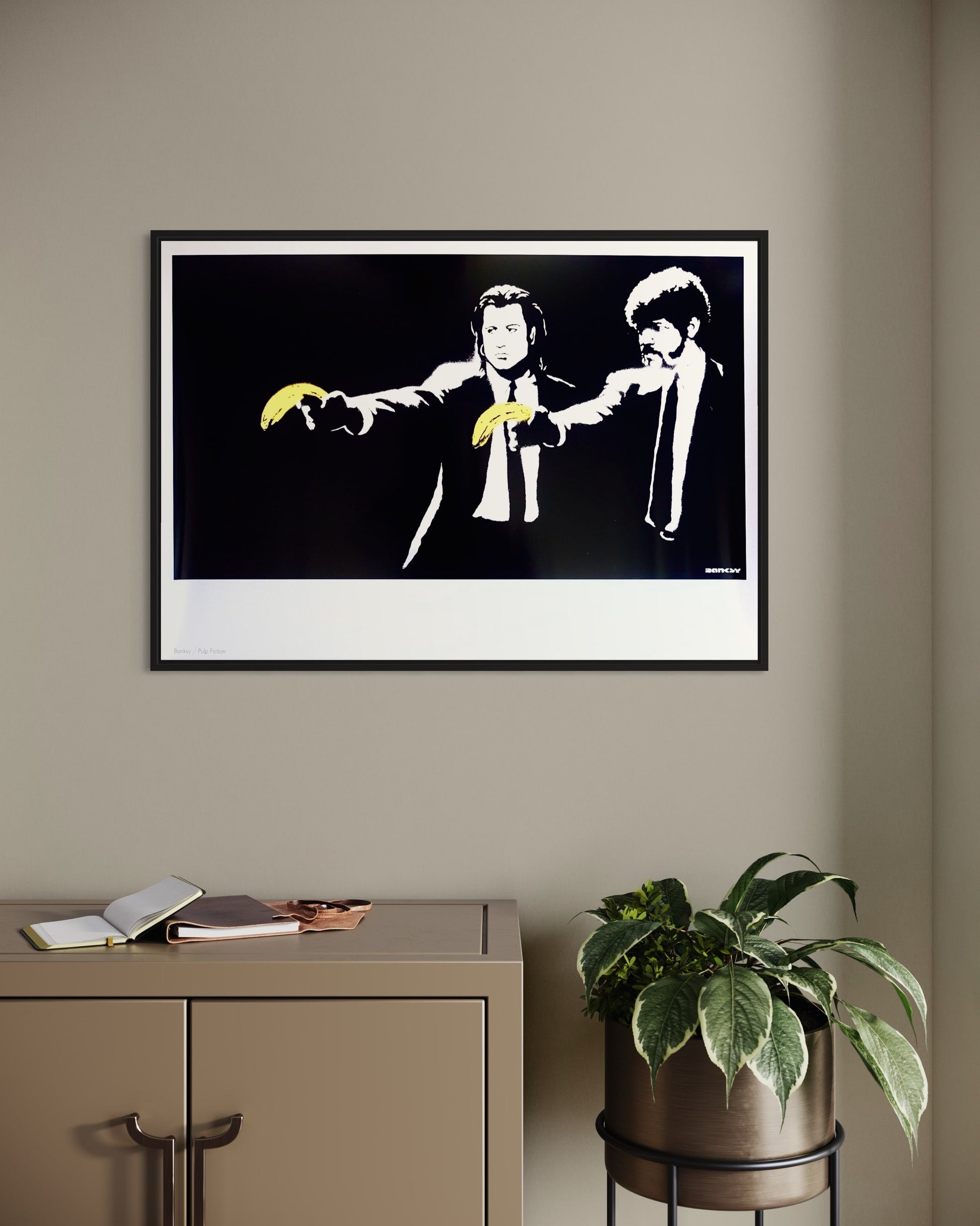 Framed 'Pulp Fiction' print by Banksy hanging on a wall, adding a unique and thought-provoking touch to the decor.