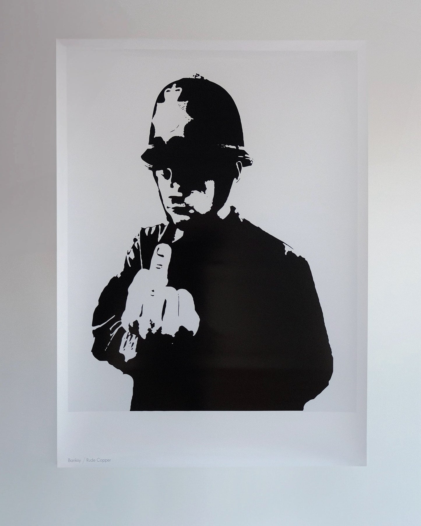 Detailed image of Banksy's 'Rude Copper' print, showcasing the policeman with a middle finger gesture.