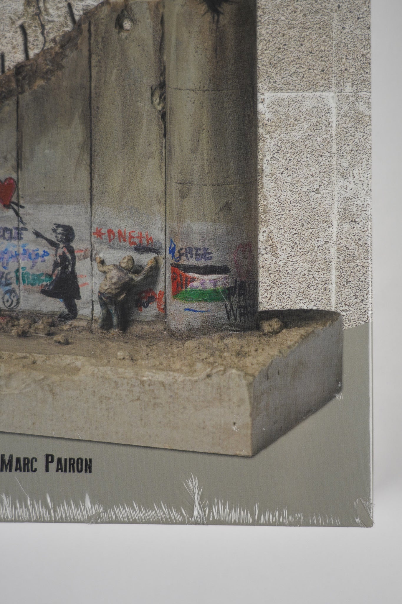 Detailed close-up of the corner of the front cover of "Banksy: The Walled Off Art Editions Are Sold Out" showcasing the artwork on the front cover.