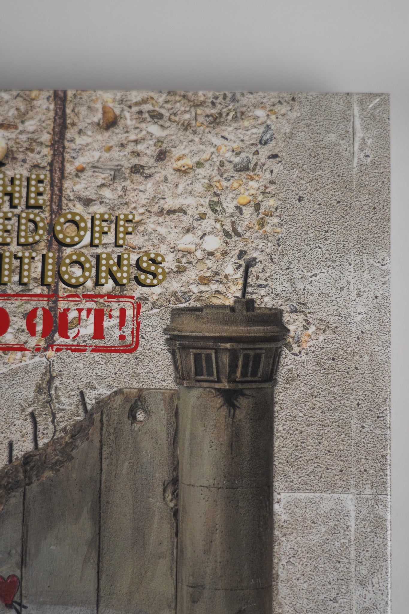 Detailed close-up of the corner of the front cover of "Banksy: The Walled Off Art Editions Are Sold Out" showcasing fine finish.