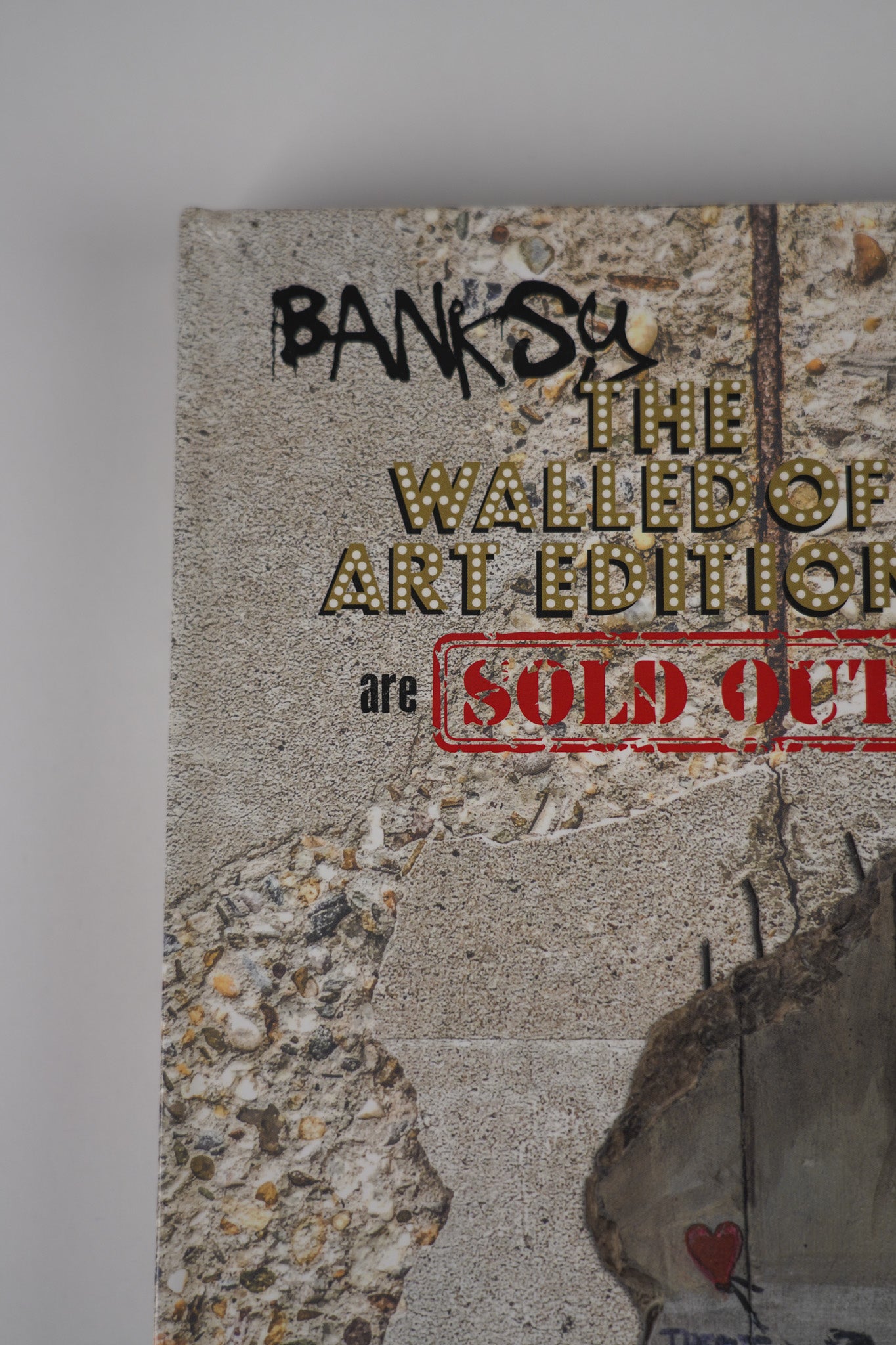  Close-up of the title on the front cover of "Banksy: The Walled Off Art Editions Are Sold Out" by Marc Pairon, highlighting typography details