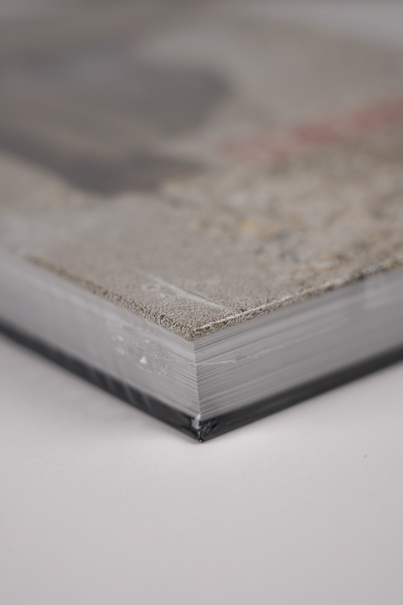 Top right corner of the front cover of "Banksy: The Walled Off Art Editions Are Sold Out" with fine detail of the book's edge.