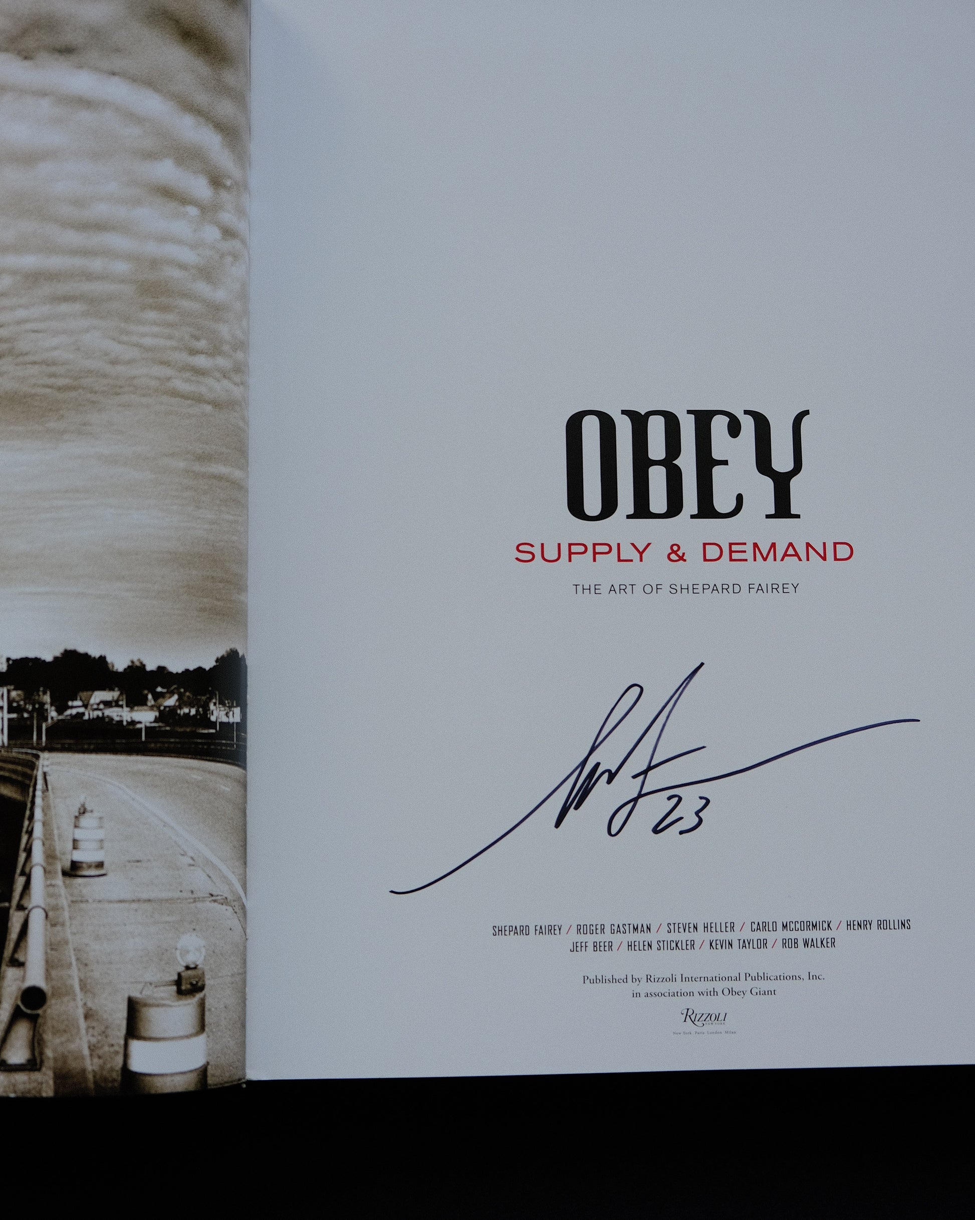 Close-up of Shepard Fairey's signature on 'Obey: Supply & Demand - The 20 Year Edition'.