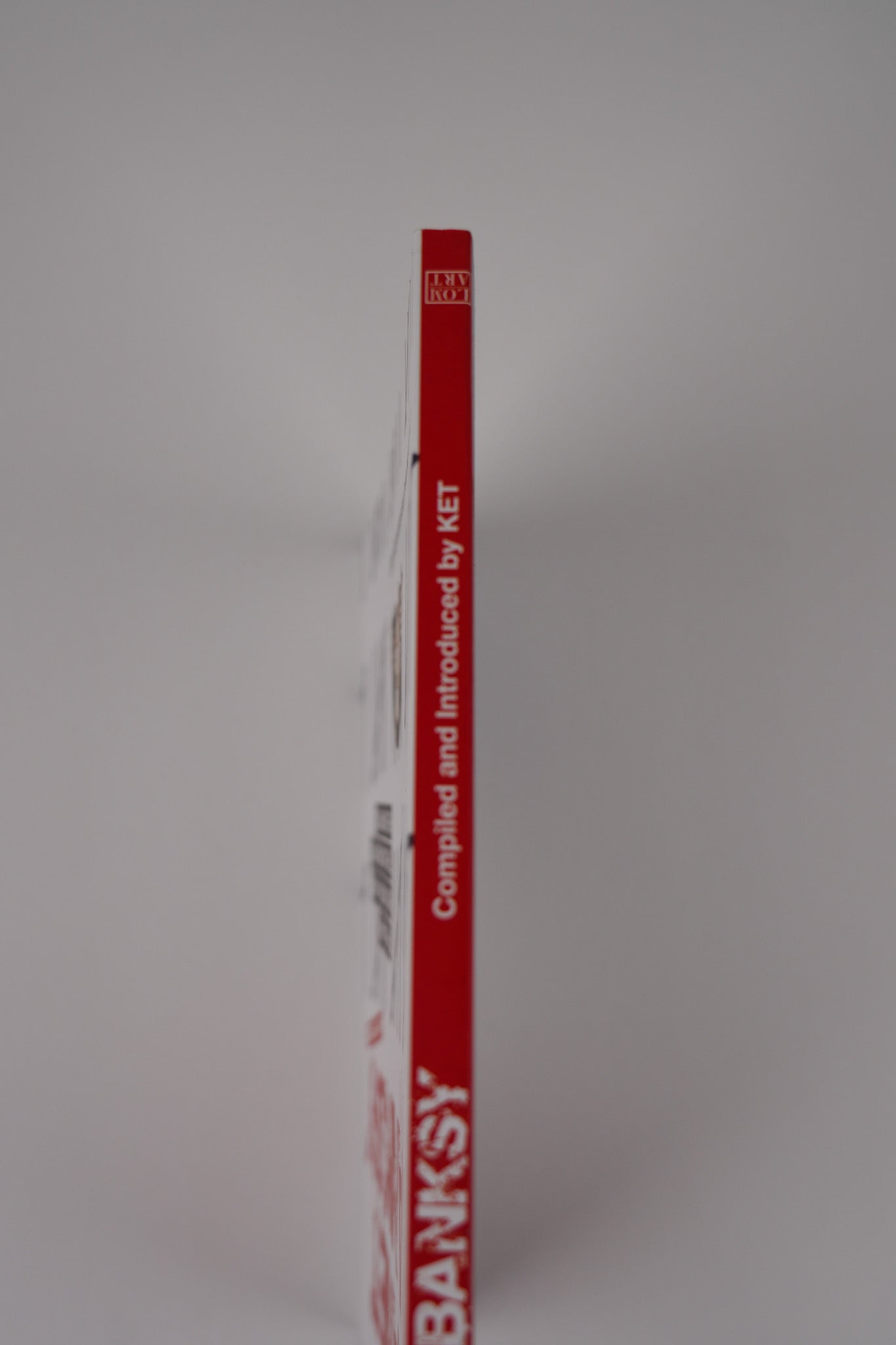 Spine of "Planet Banksy," displaying "Complied and Introduced by KET".