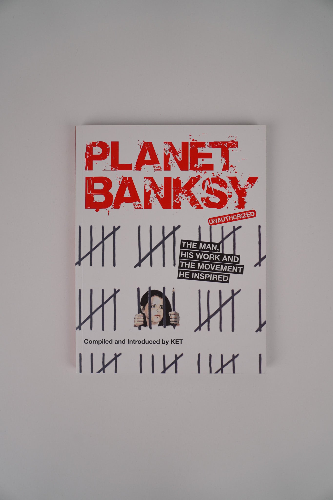 Front cover of the book "Planet Banksy" by graffiti artist KET, featuring colorful urban street art design.