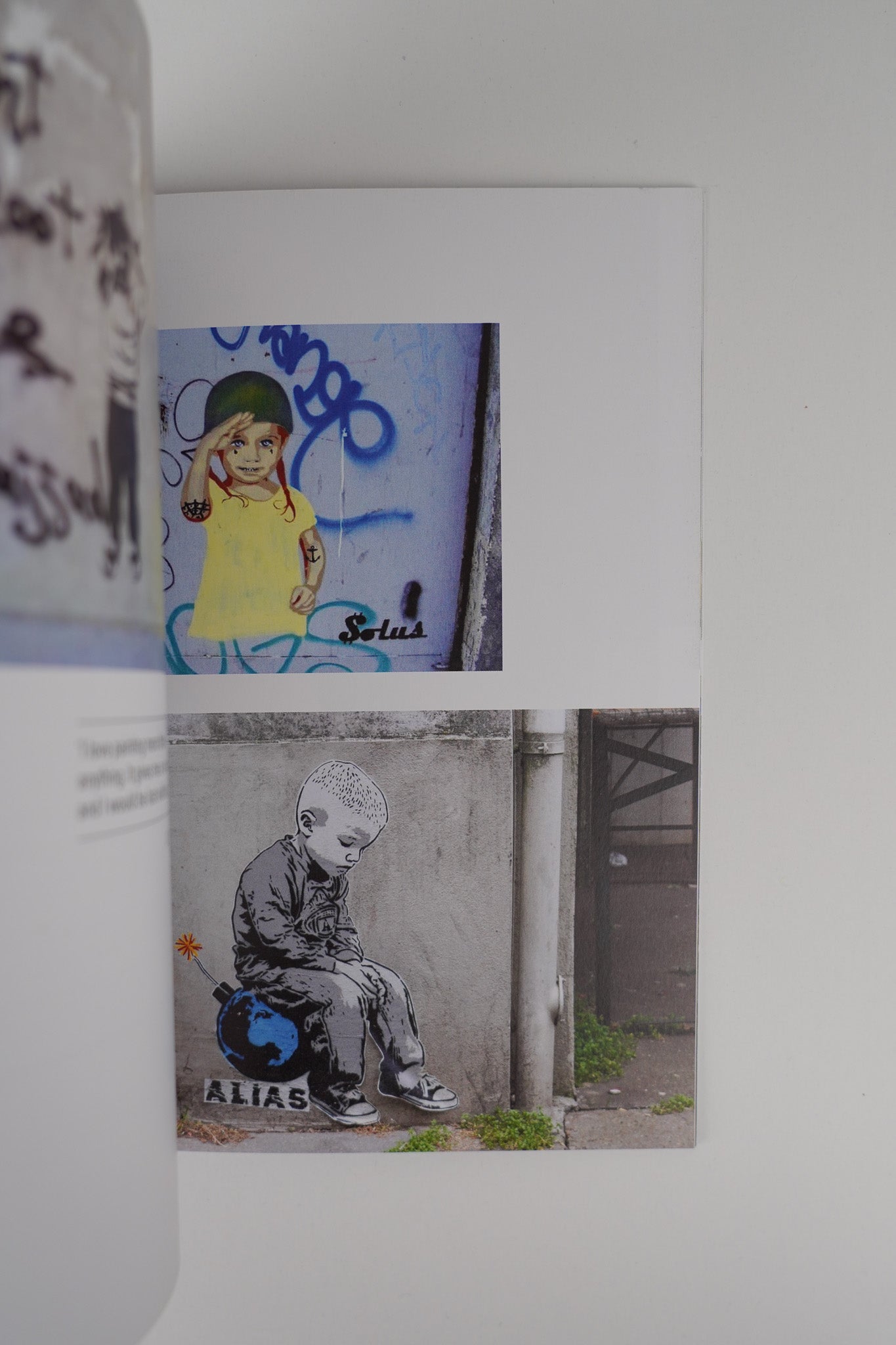 Open pages of "Planet Banksy," displaying vibrant illustrations and commentary on street art.